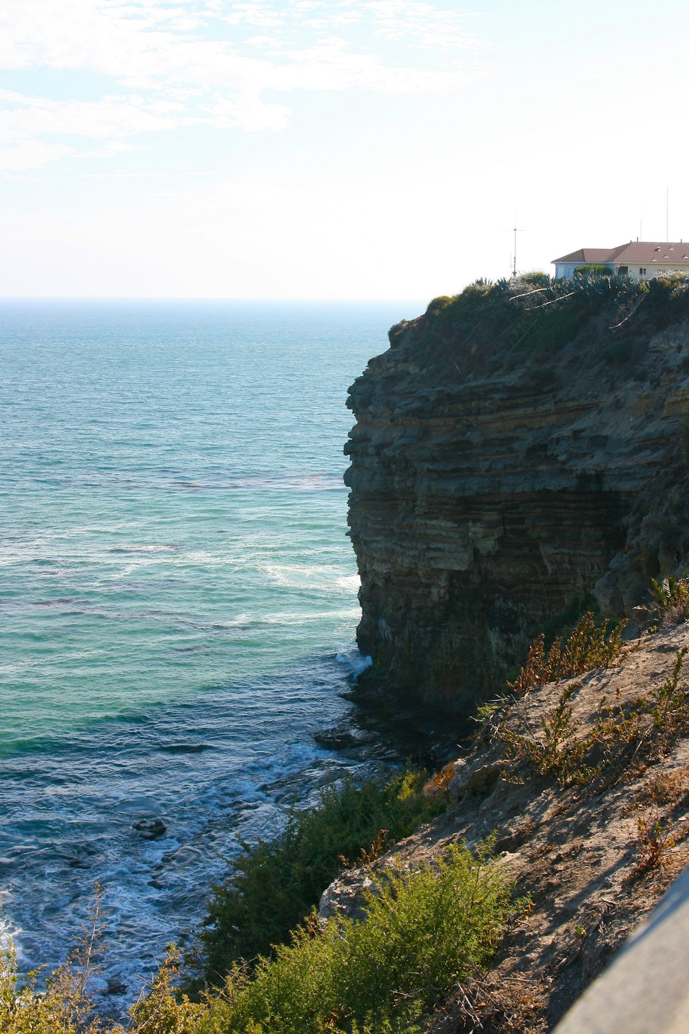 photography of mountain cliff and seashore during daytime
