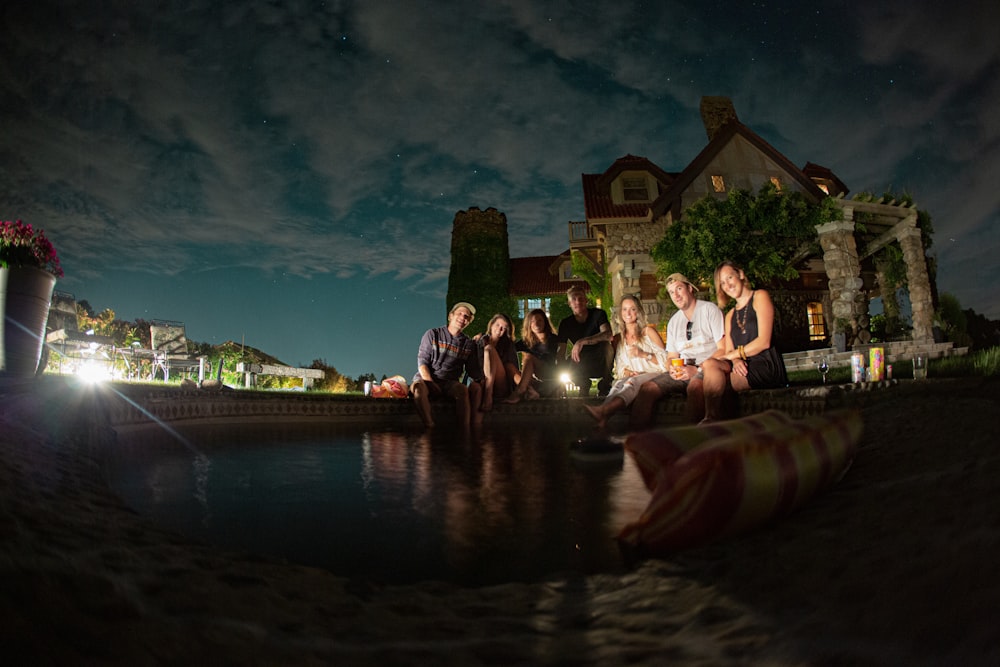 people sitting beside pool