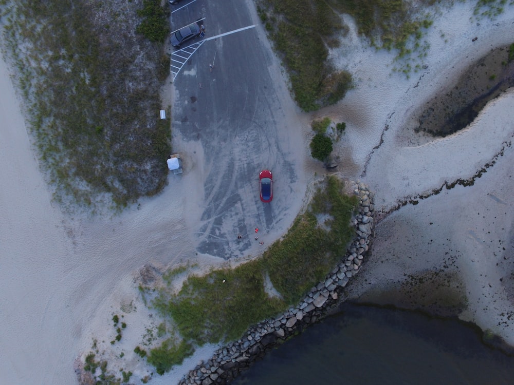 aerial photo of red vehicle on road