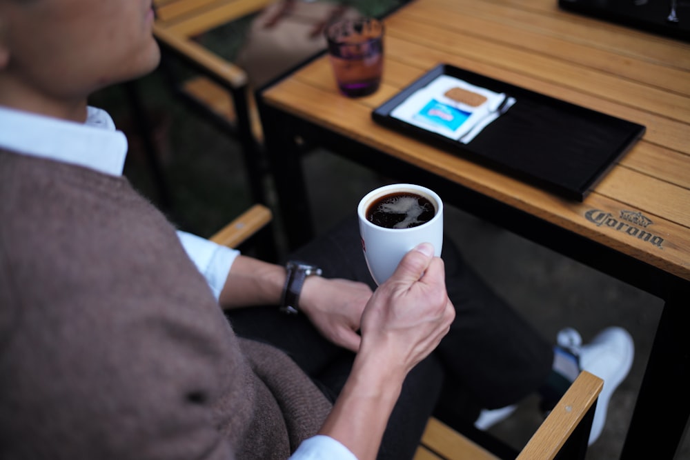 person holding mug