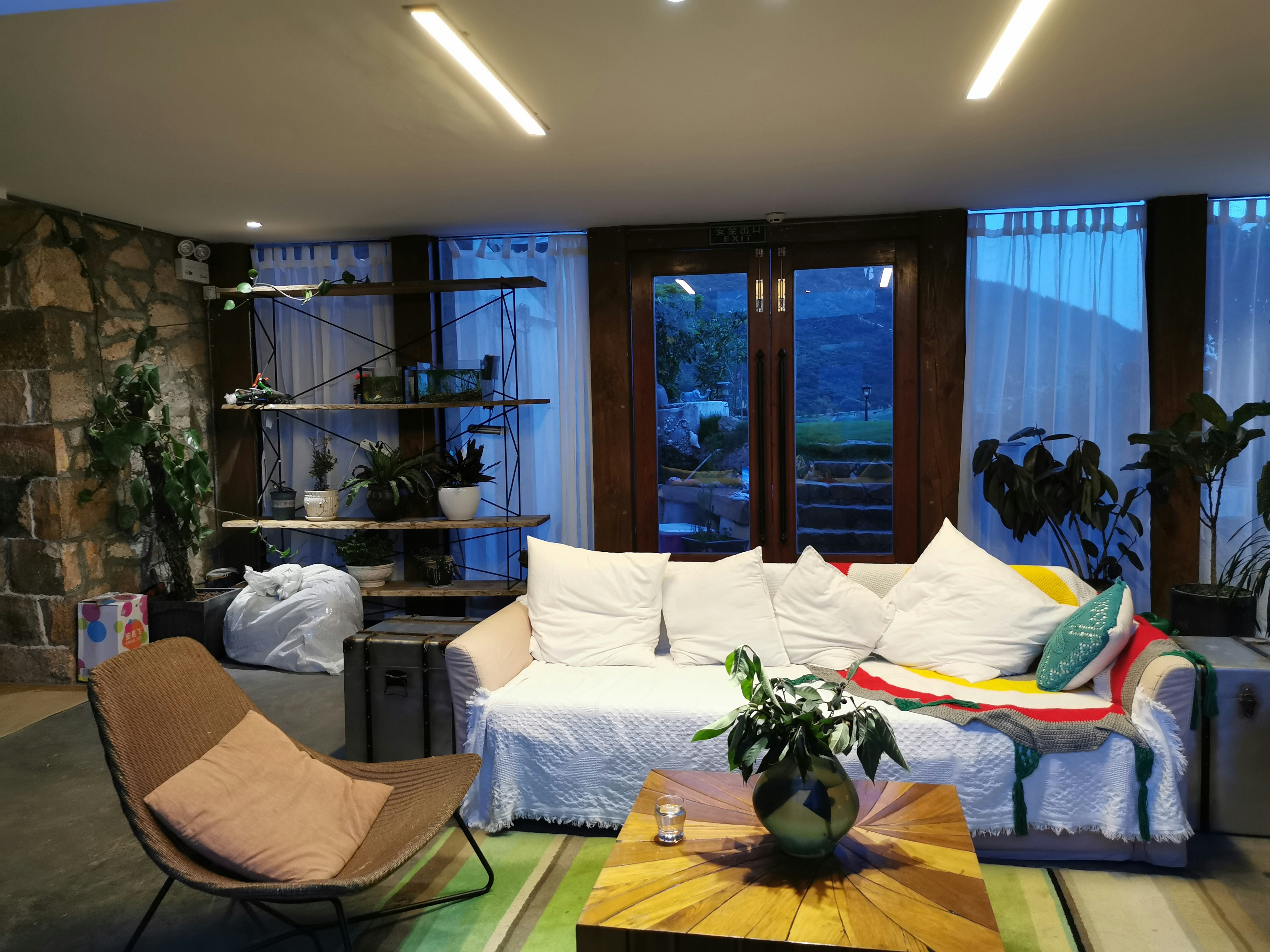 Warm family home interior at dusk, soft glowing lights, cozy living room, dark wood floors