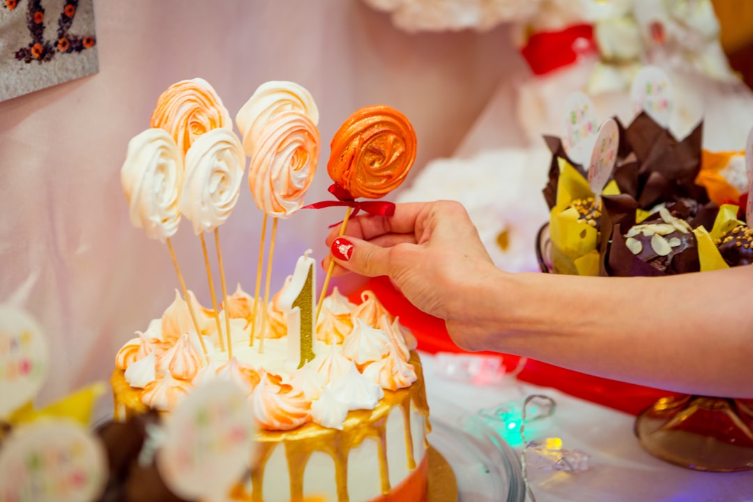 woman with red manicure touching cake topper