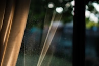 A close-up of dust particles floating in a sunbeam streaming through a window.
