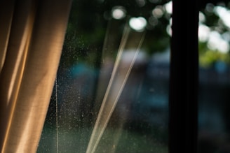 A close-up of dust particles floating in a sunbeam streaming through a window.