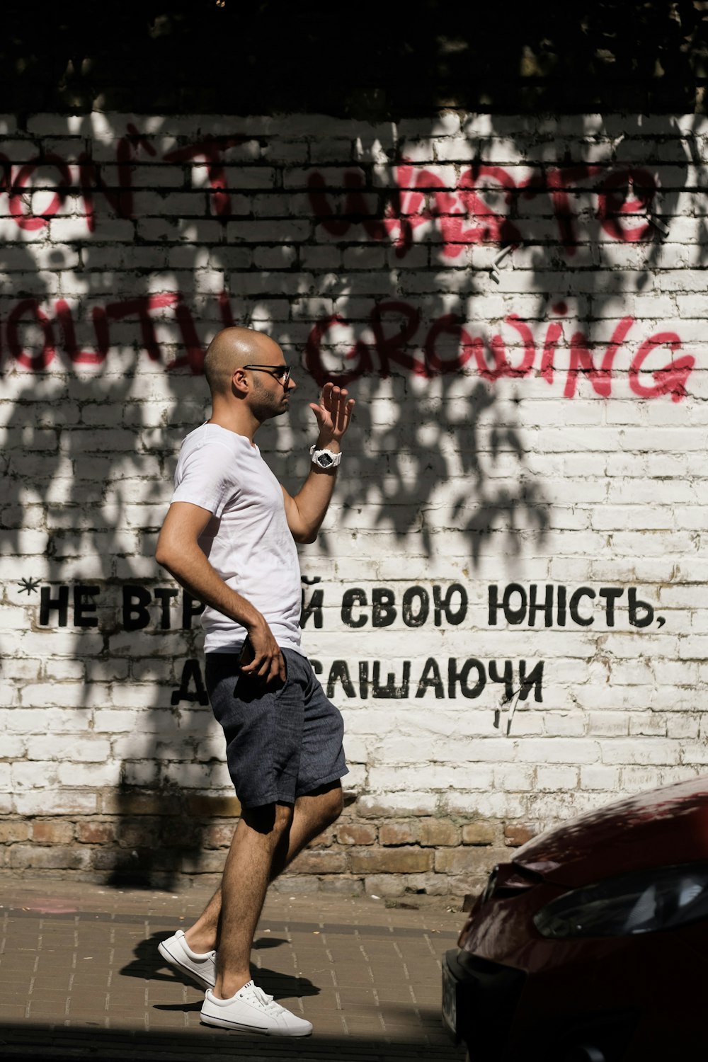 man walking on sidewalk