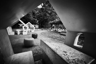 Black and white photo of a sleek, modern stone patio with clean lines and minimalist design.