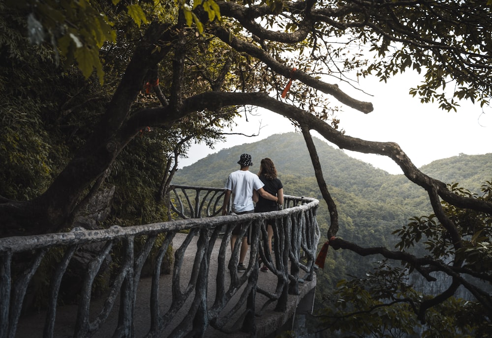 man and woman walking on road