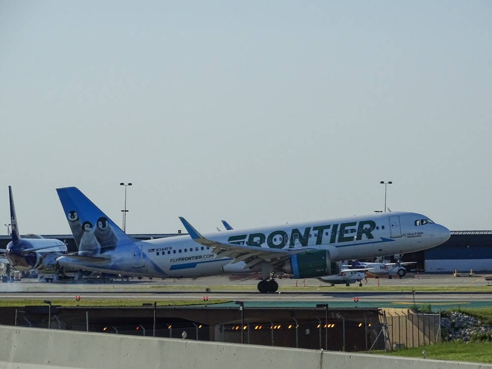 green and white Frontier airliner