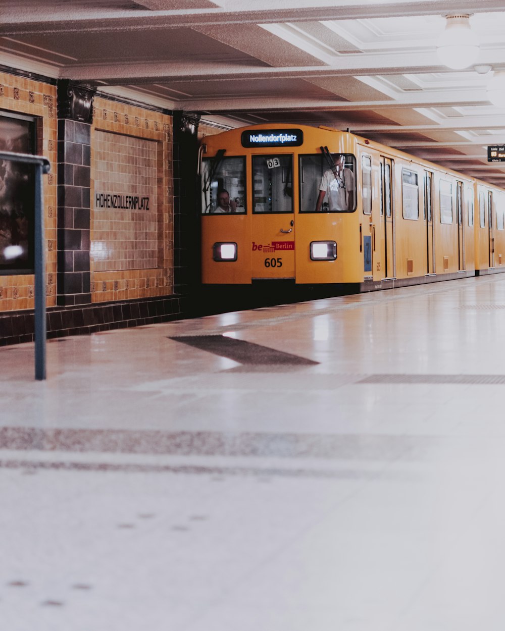view of yellow orange train inside subway station
