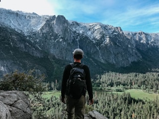 man standing on rock mountain