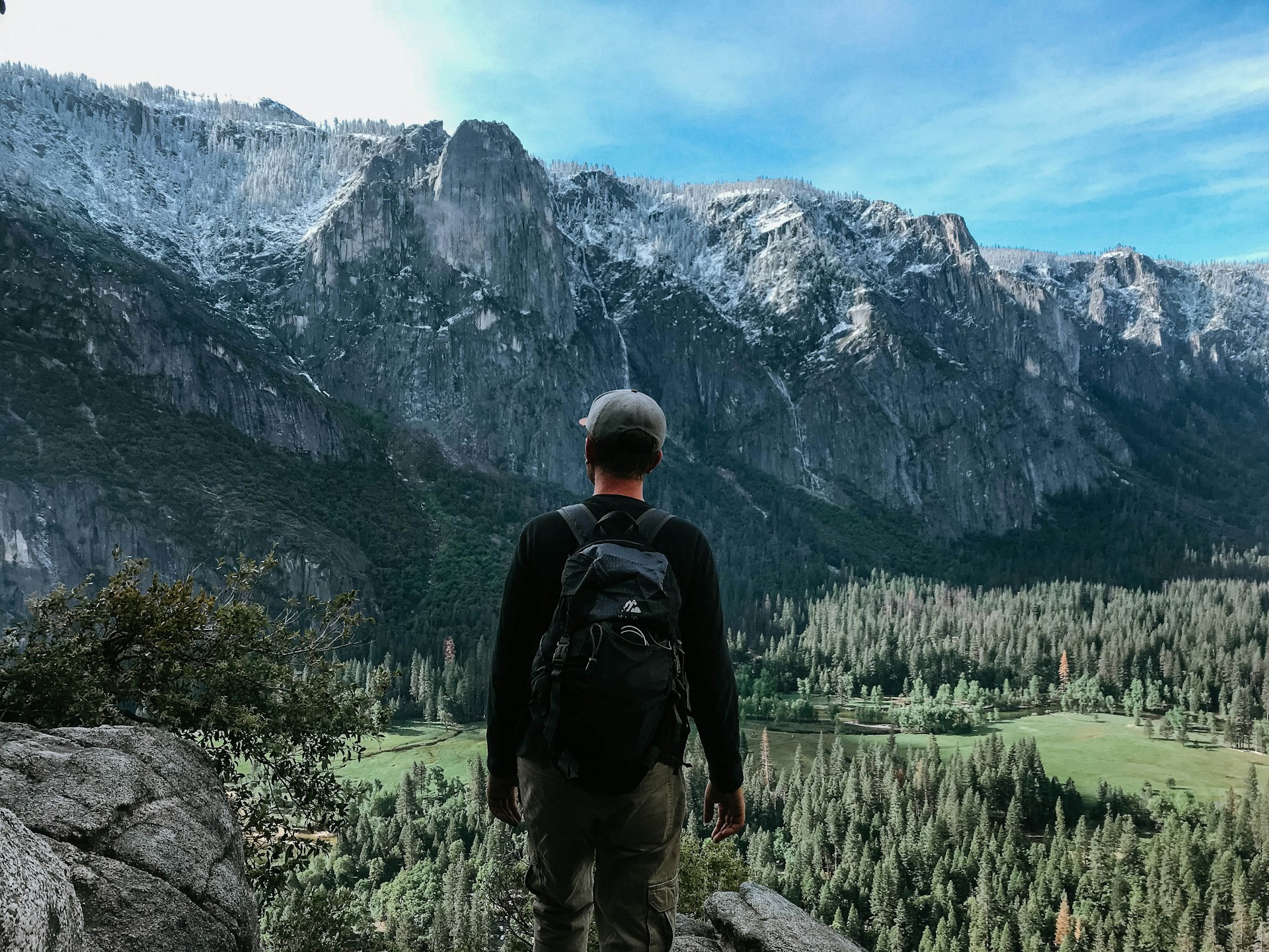 man standing on rock mountain