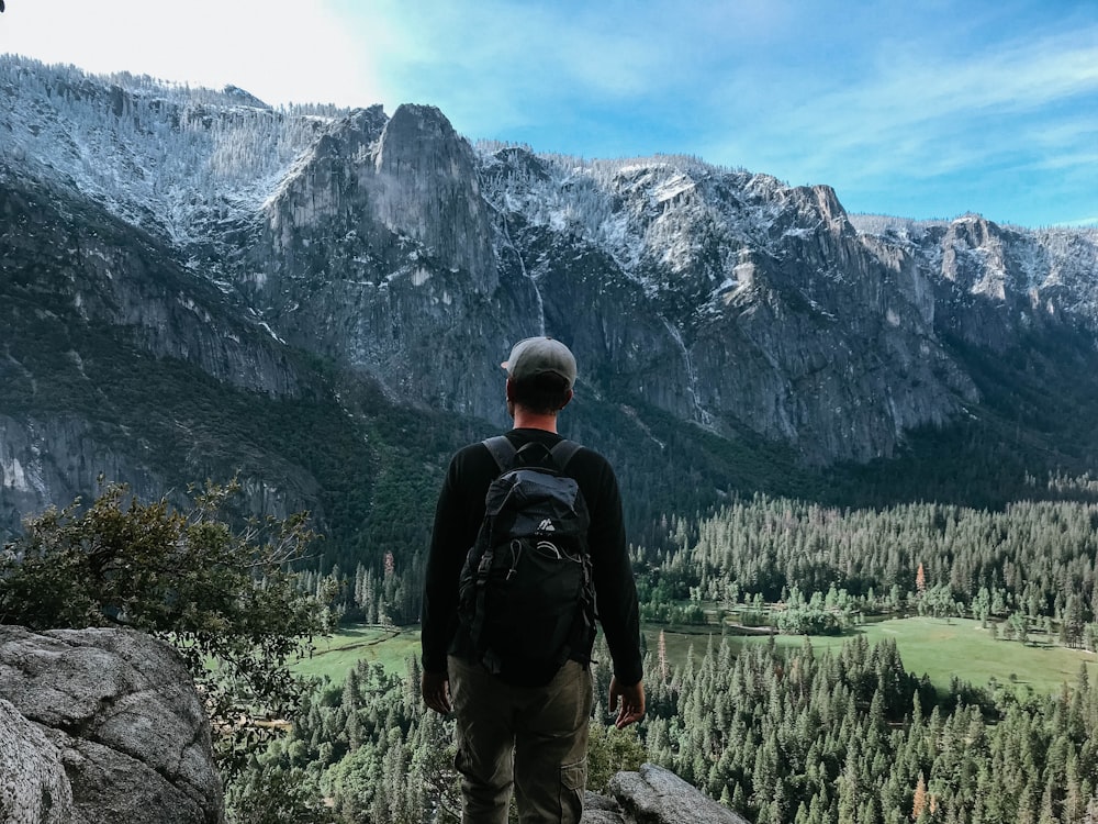 Hombre de pie en la montaña de roca