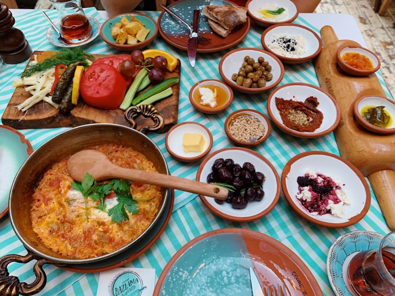 a table covered in small plates of food|500