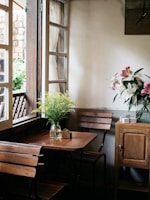 A cozy corner decorated with light fabrics and subtle floral arrangements.