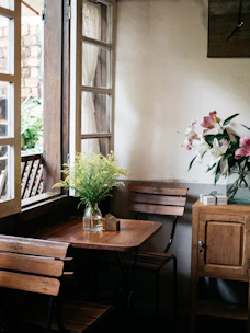 Bright common study area with soft floral accents and quiet ambiance.
