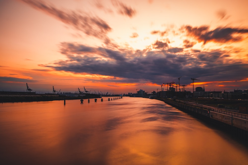 harbor under grey and orange sunset sky