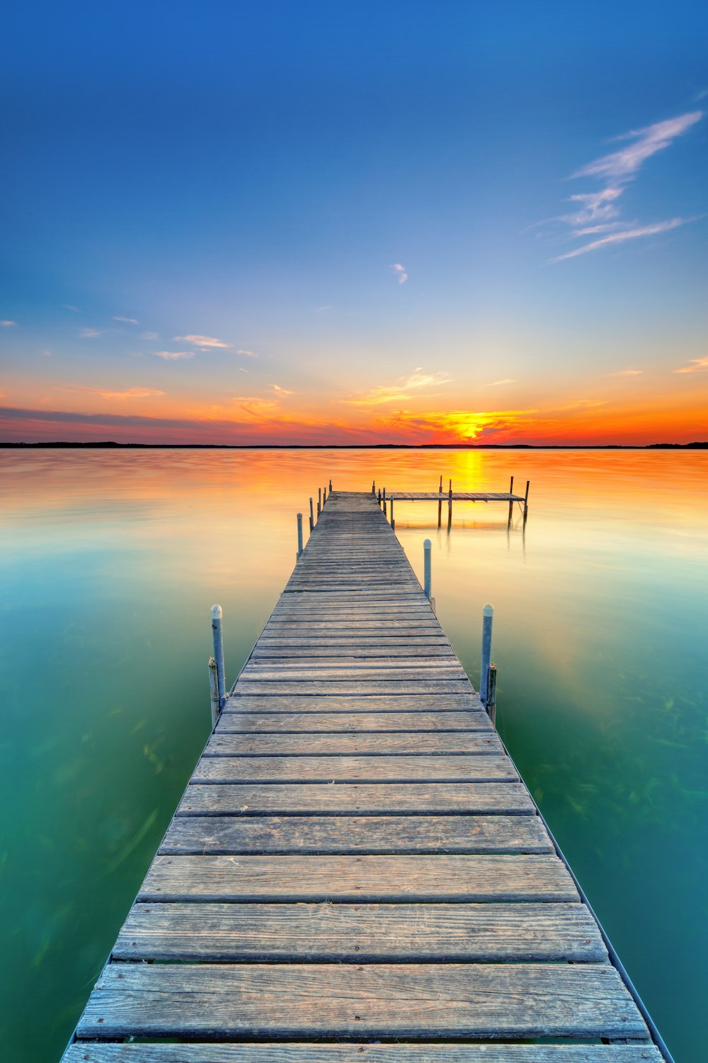 gray wooden beach dock viewing sea