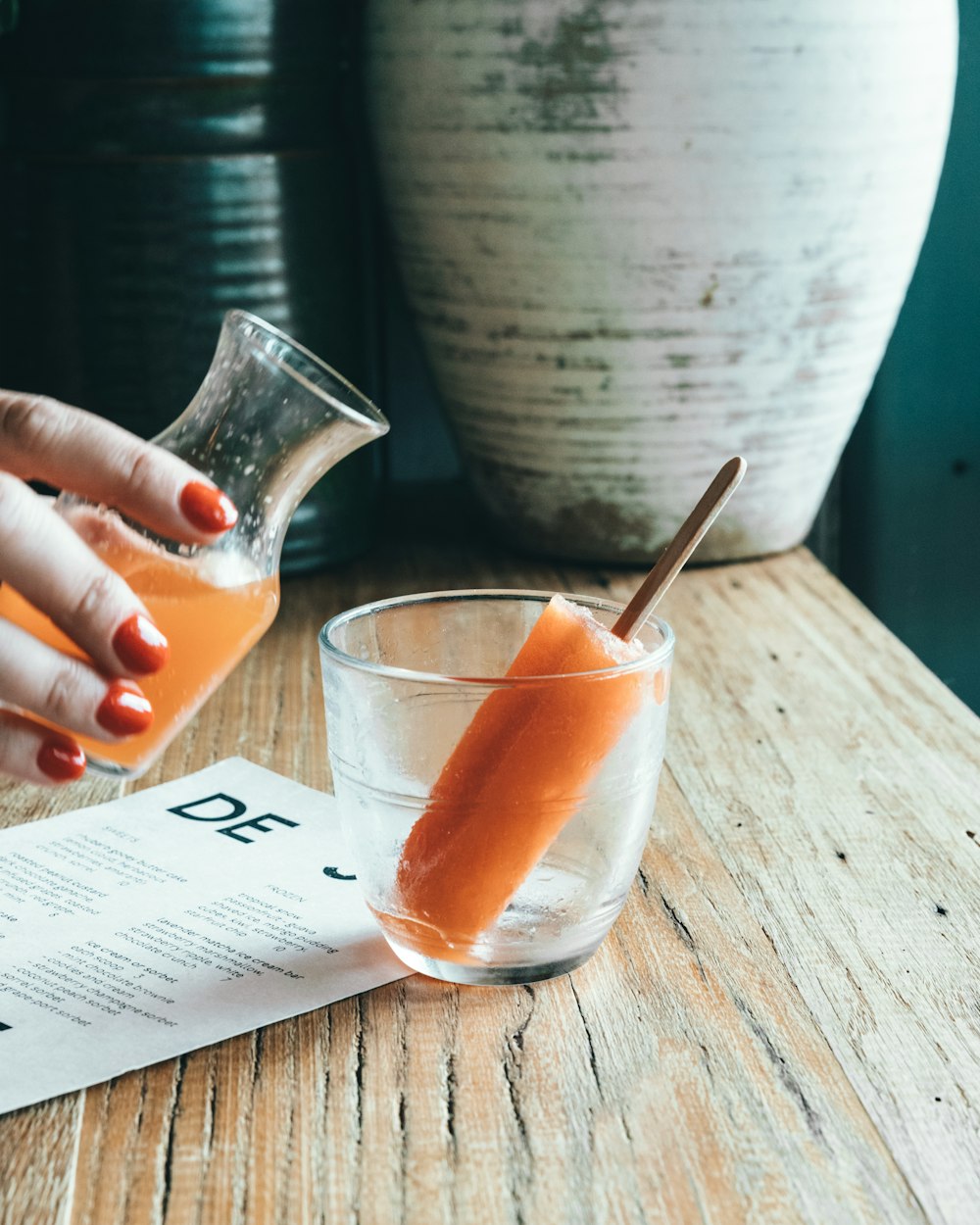 person holding clear glass cup