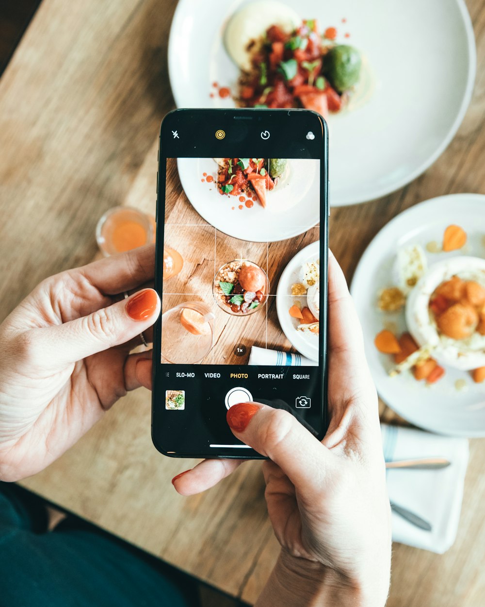 person taking photo of food