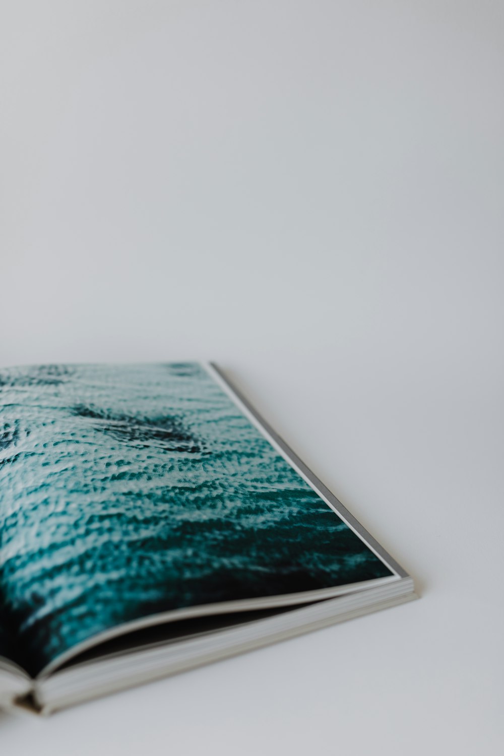 an open book with a picture of a boat in the water