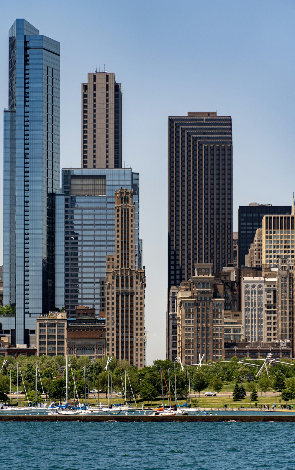 tall building lot near trees and body of water during daytime