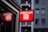A brightly lit red sign displays the word 'Internet' with the @ symbol, mounted outside a building with a modern facade and several windows.