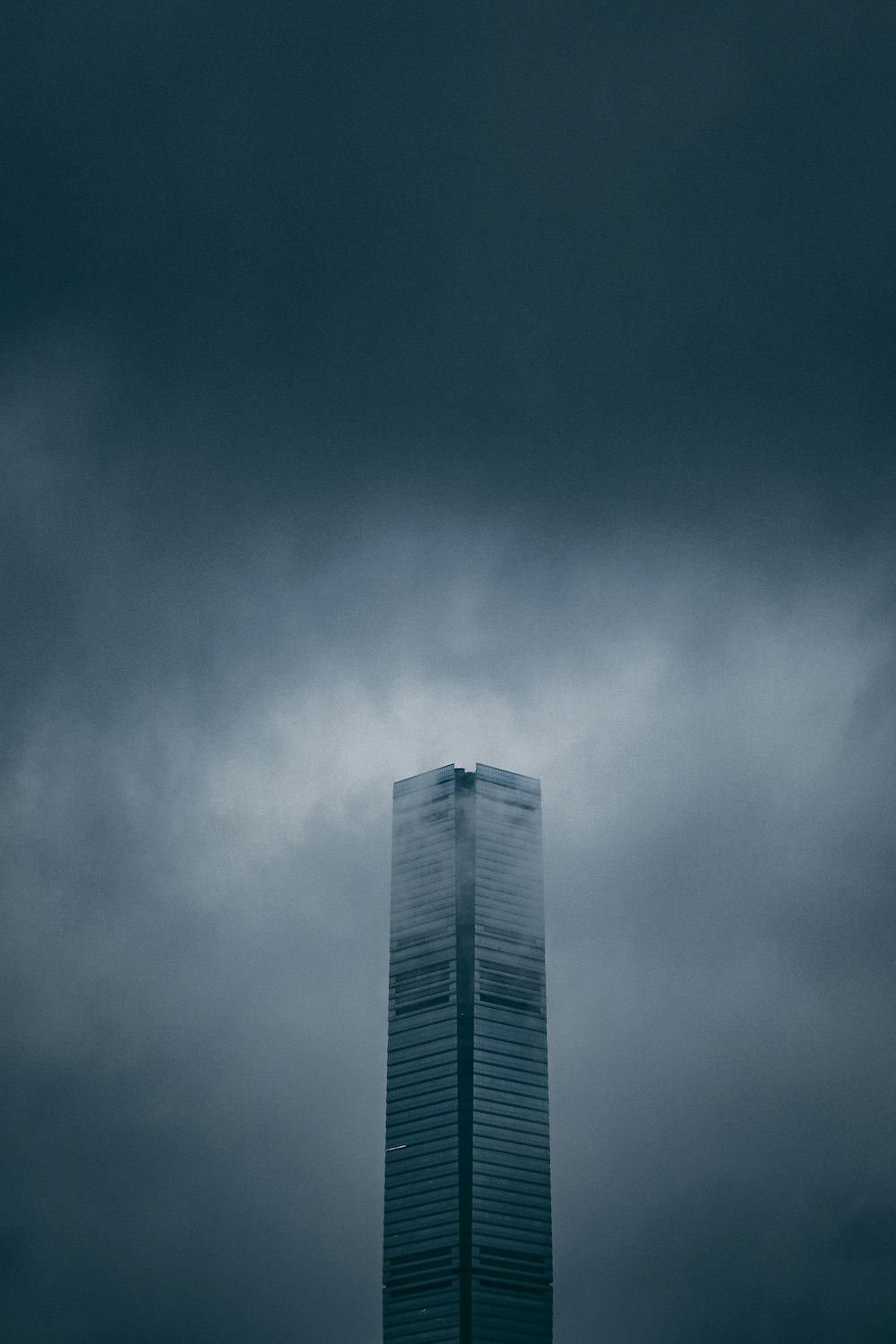 grey building under grey clouds