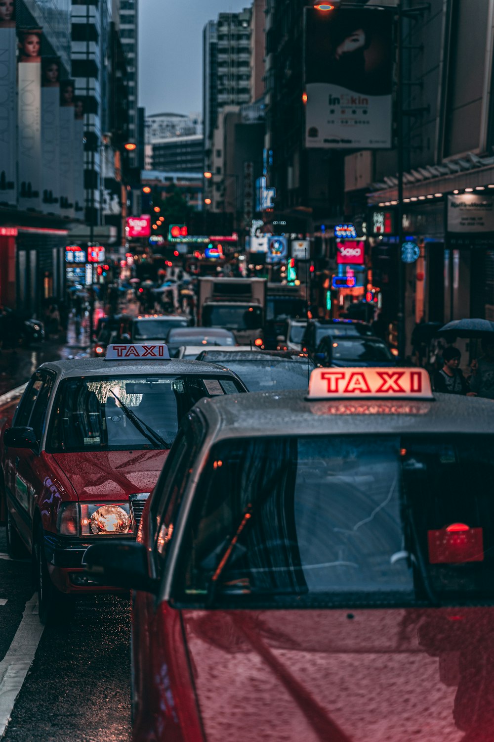 red and gray taxi vehicles