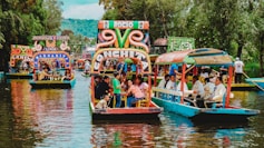 people riding tour boats during daytime