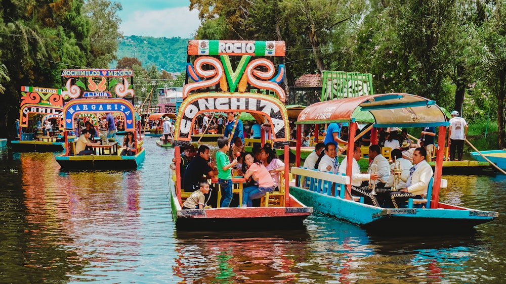 people riding tour boats during daytime