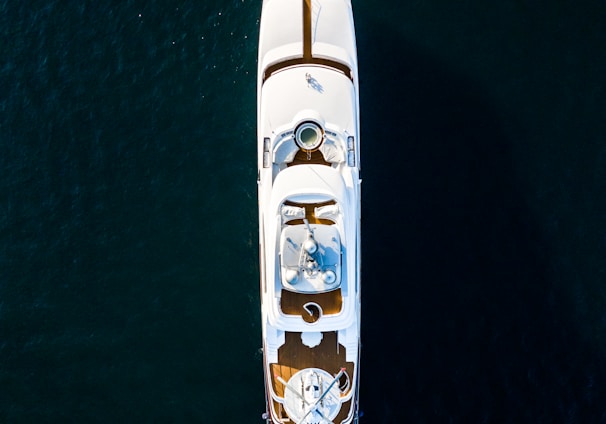 white and brown boat on body of water at daytime