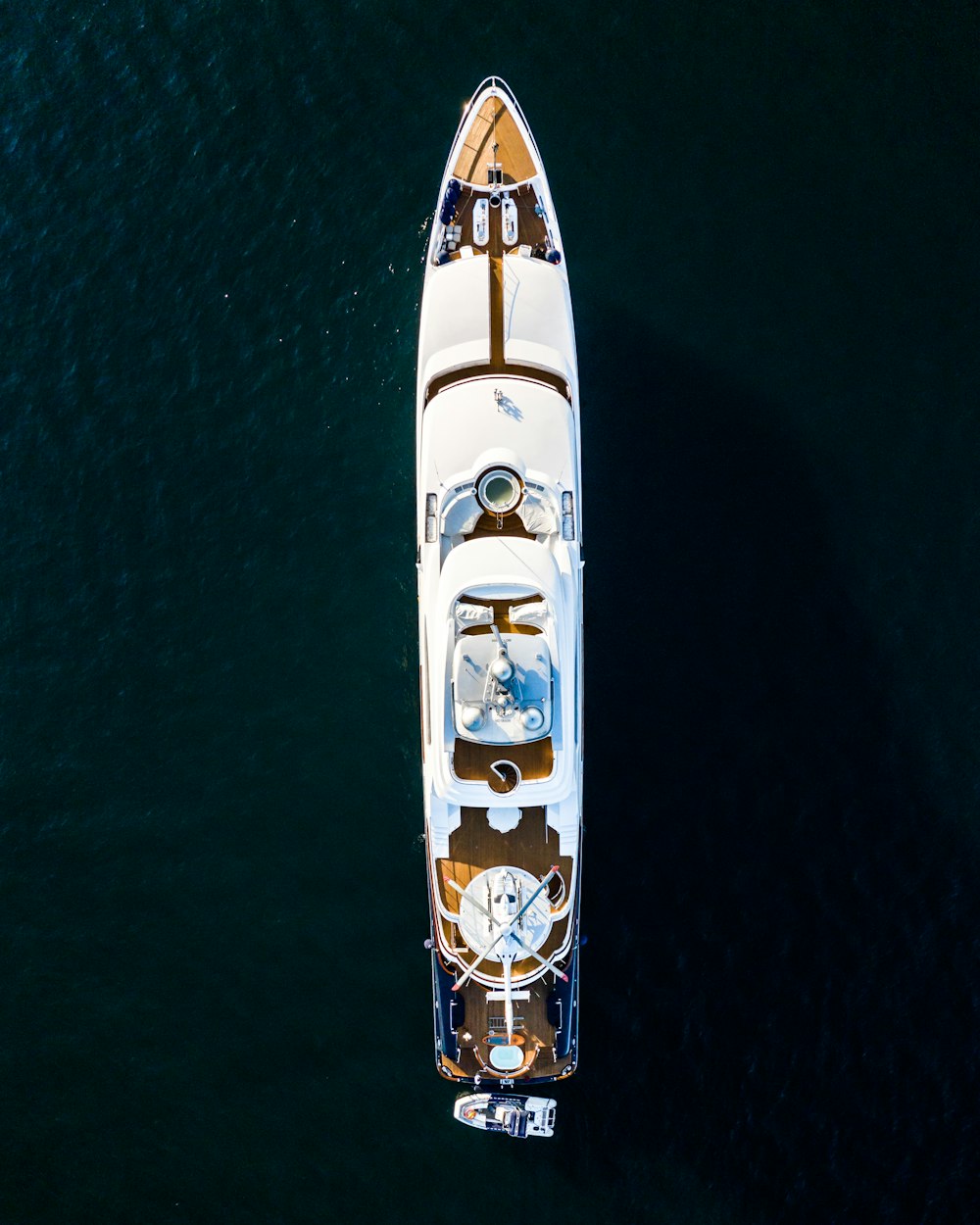 white and brown boat on body of water at daytime