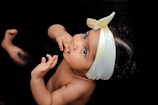 toddler wearing yellow ribbon close-up photography