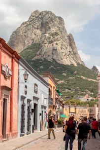 Scenic view of a traveler exploring a colorful street in a historic town.