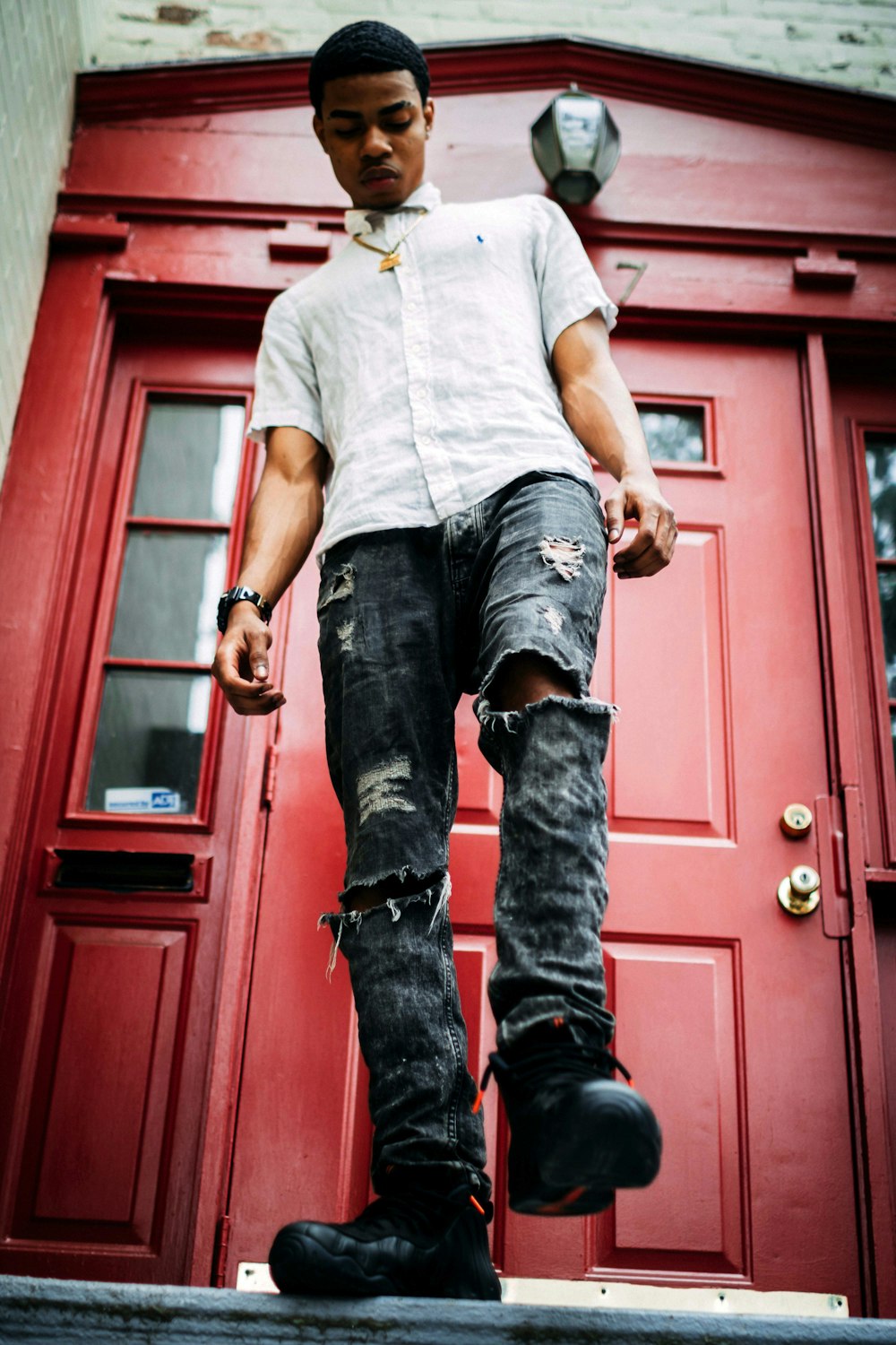 mans standing in front of closed red door