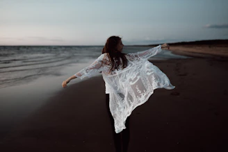 Lightweight beach cover-up flowing in the breeze near the ocean shore