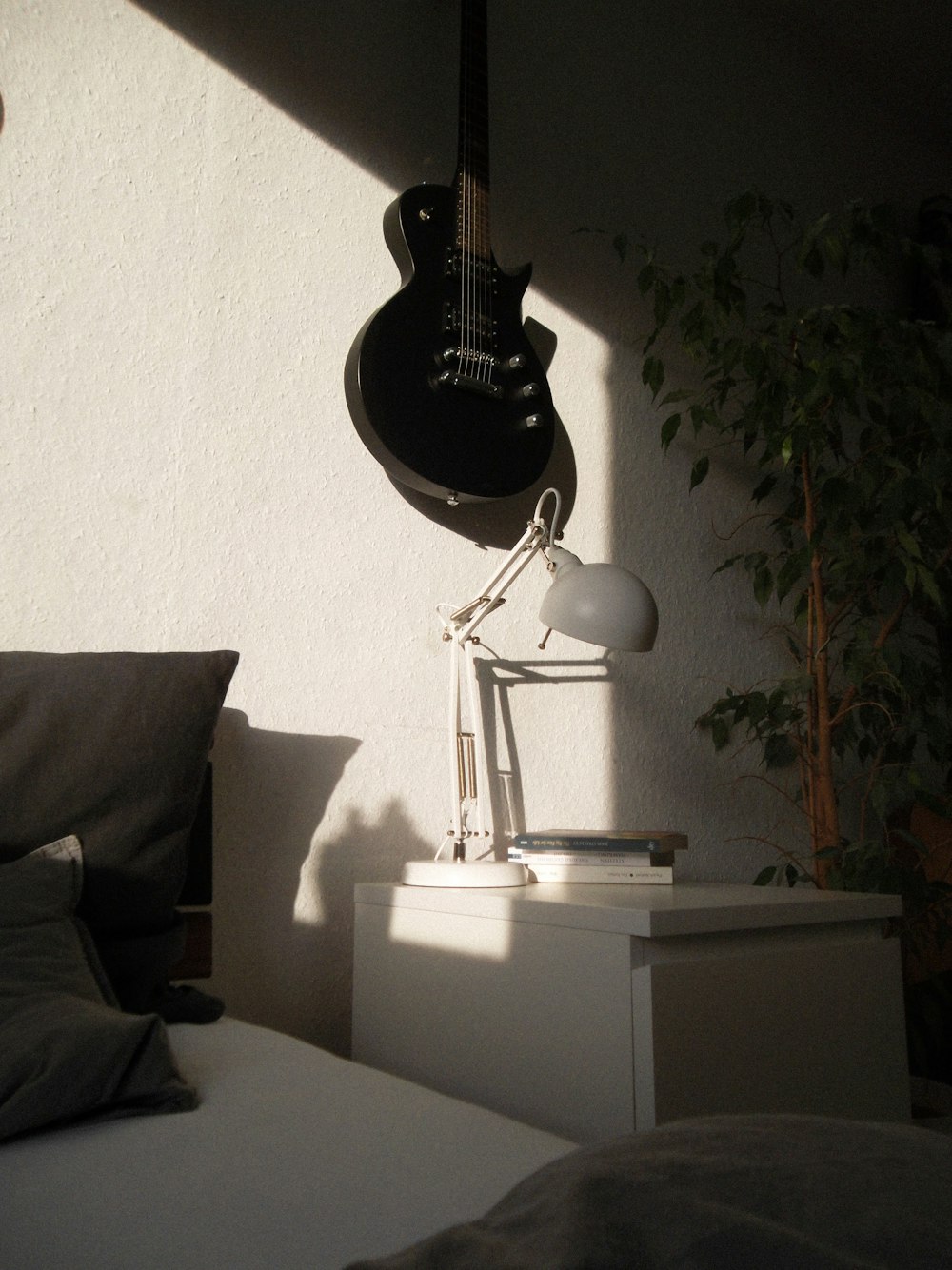 black guitar hanged on walll