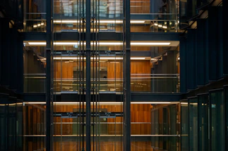 A sleek modern office interior showcasing drywall partitions with subtle golden accents under soft lighting.