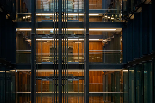 A sleek modern office interior showcasing drywall partitions with subtle golden accents under soft lighting.