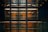 Several floors of an office building are visible through large glass walls. The interior features a modern, industrial design with exposed structural elements and wooden paneling. Horizontal lighting fixtures illuminate the space along the corridors.