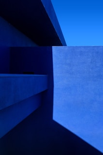 Abstract modern architecture with clean lines and deep blue shadows.