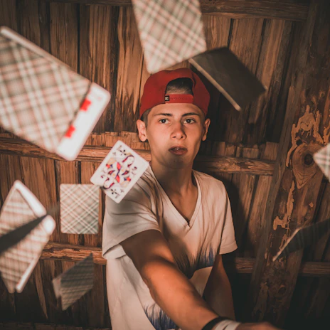 Close-up of a red hat and deck of cards resting on a black tablecloth during a trade show magic session.