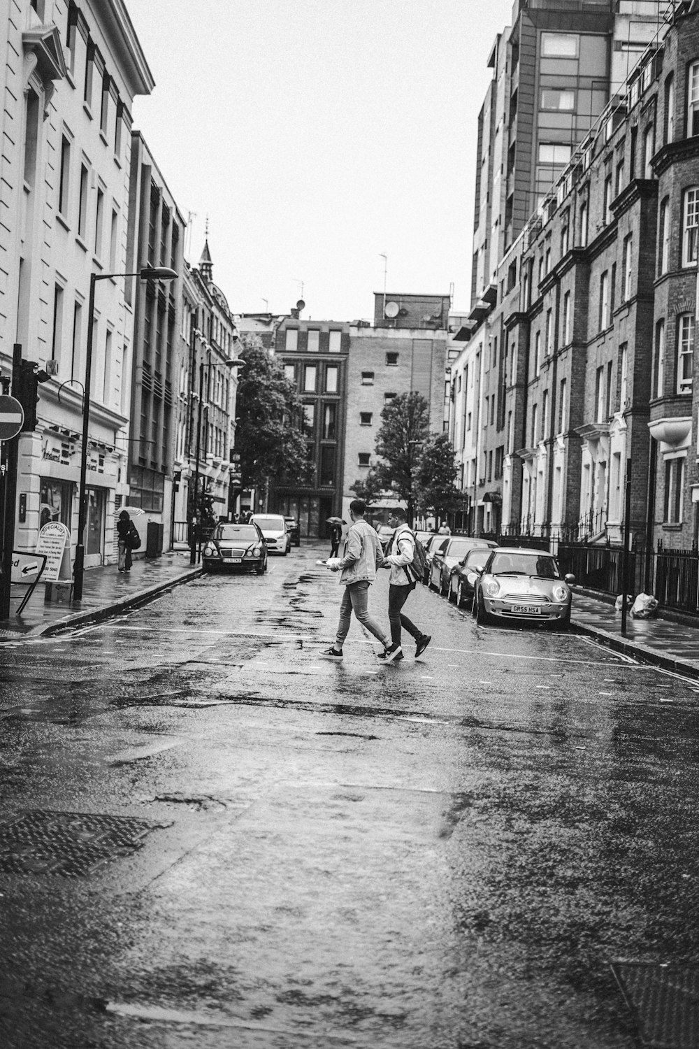 grayscale photo of person walking on road