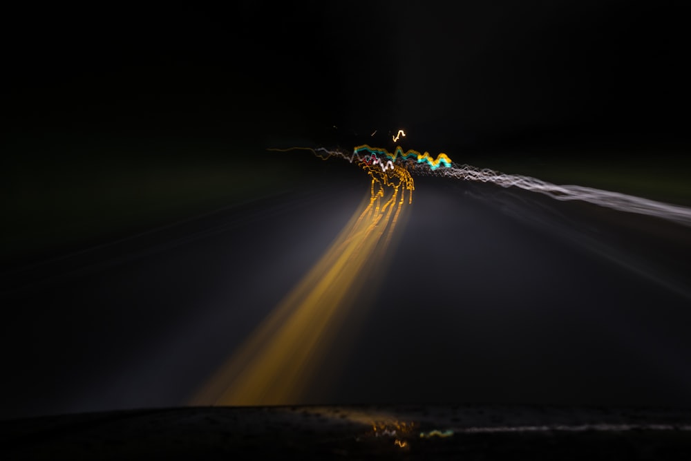 a car driving down a dark road at night