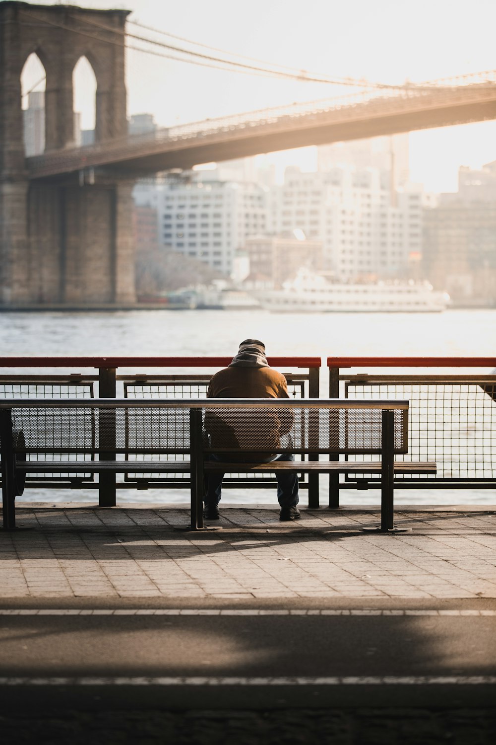 man sitting on bench near sea