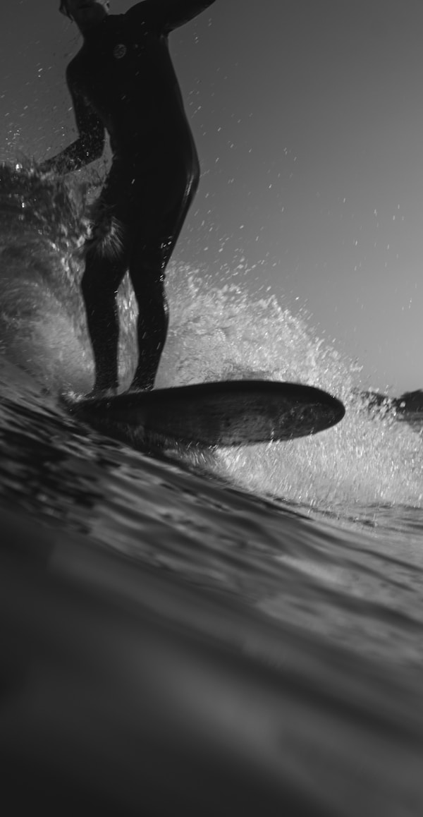 man riding on surfboard