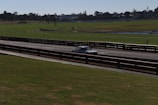A classic 1955 Chrysler road race car on a racetrack.