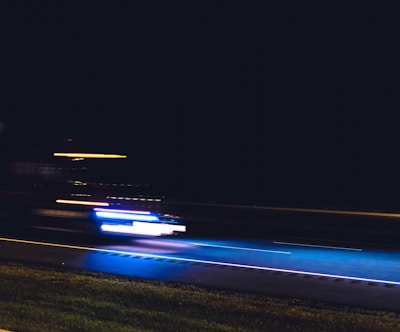 A grainy photo of a getaway vehicle speeding away from a crime scene.