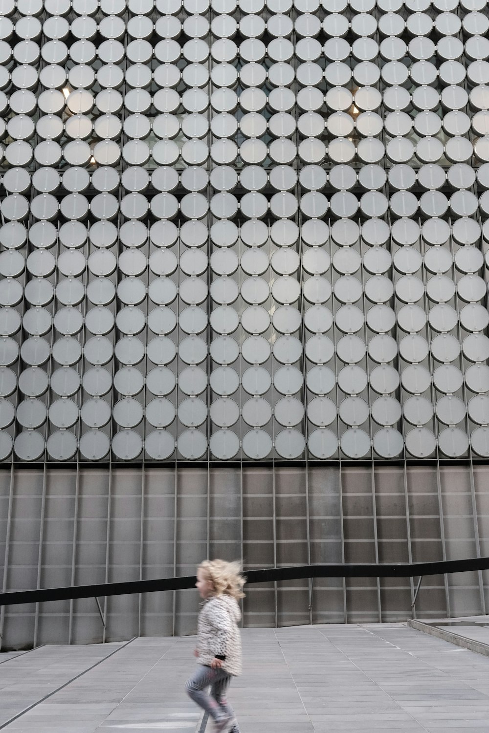 kid walking near building