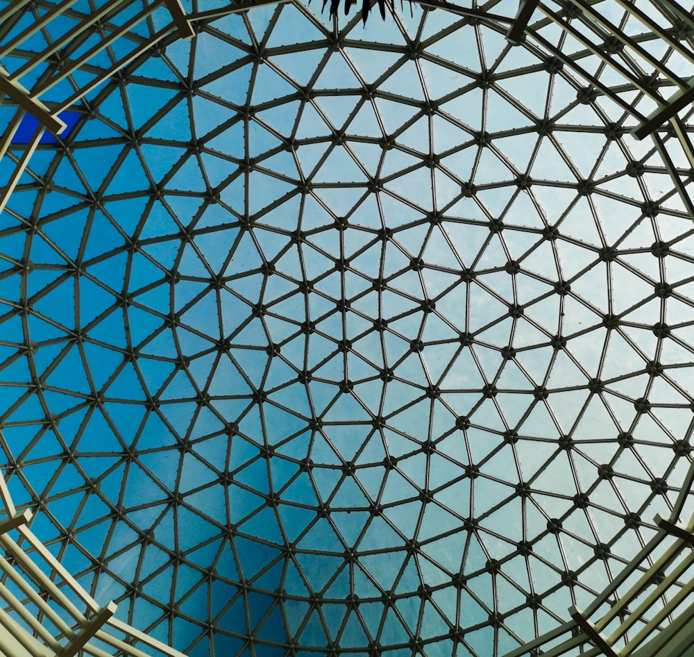 a close up of a metal structure with a blue sky in the background